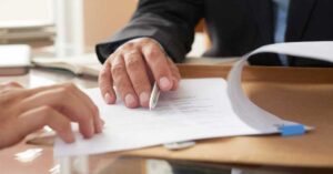 Auditor reviewing compliance checklist at a licensed facility