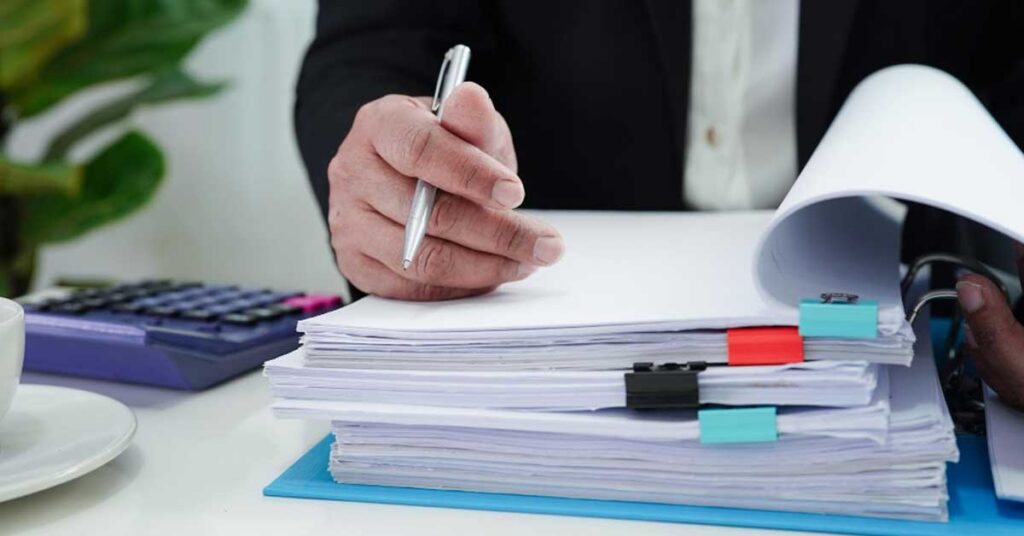 Regulatory professional reviewing FDA 510(k) submission documentation on a laptop