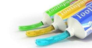 Infographic illustrating toothpaste classification health canada framework showing OTC drug, NHP, and cosmetic categories
