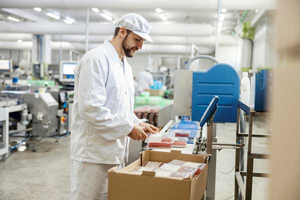 Quality control professional reviewing food packaging materials as part of a food contact notification submission
