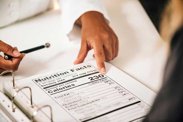 Regulatory professional reviewing nutrition facts label as part of FDA health claim substantiation process